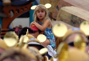 Olivia Reinoso age 5 of Camarillo sits on top of her father Marc's Reinoso's shoulders surrounded by hundreds of guests wearing the golden Mickey 50th ears as they waited on Main street for the offical birthday celebration event to begin Sunday morning July 17, 2005.